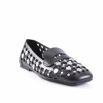 Black slip-on shoe with a lattice cut-out design and round metal studs across the upper surface