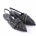 Black leather slingback flats with pointed toes and multiple studded straps with buckles.