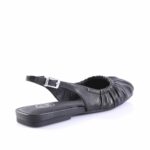 Black leather flat sandal with an adjustable ankle buckle and gathered upper strap (open toe).