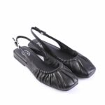 Black leather slingback ballet flats with a ruched front and a small ankle strap for a secure fit.