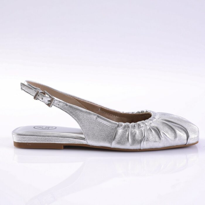 Silver metallic slingback flat sandal with a ruched front, ankle buckle, and light brown sole on a white background.