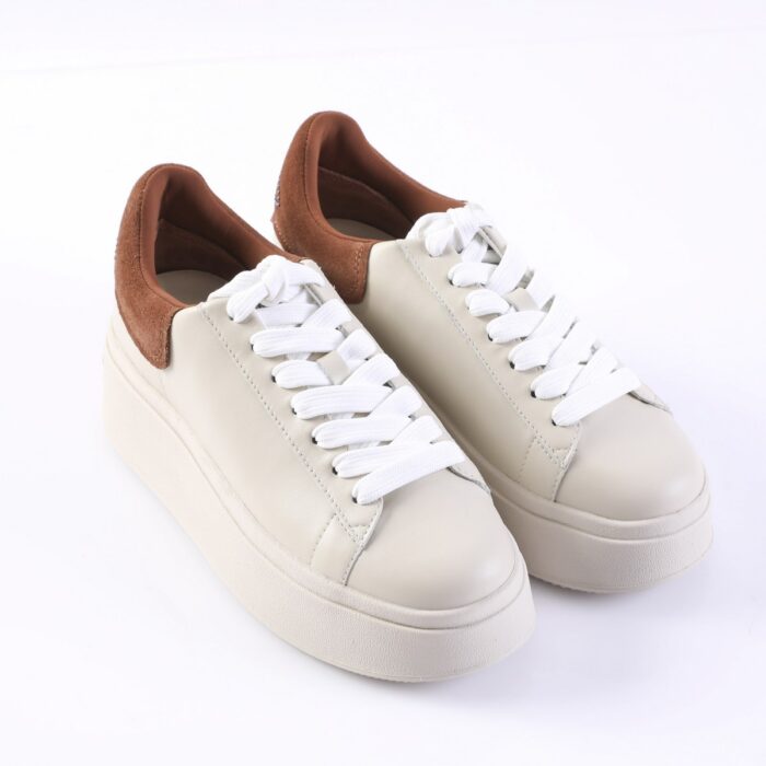 Beige platform sneakers with white laces and brown suede heel collar.