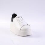 White platform sneaker with white laces and a black heel patch, shown from a front-left angle.