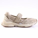 Beige athletic sneaker with a Velcro strap, mesh panels, and a chunky sole (side view). Used as a casual training shoe.