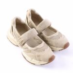 Beige athletic sneakers with two Velcro straps and mesh panels on a white background (informative product photo).