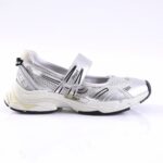 White and silver sporty sneaker with mesh panels and a Velcro strap, side view.