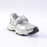 Silver athletic sneaker with a Velcro strap and black toe bumper, chunky white sole.