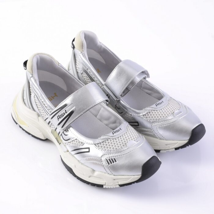 Silver athletic sneakers with mesh panels and two Velcro straps, chunky white sole, and black toe caps (brand ASH visible).