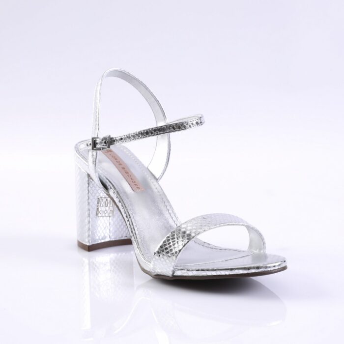 Silver metallic open-toe sandal with ankle strap and reflective block heel on a white surface