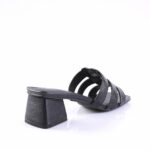 Black strappy sandal with a low square block heel, shown from the side with multiple narrow straps across the foot