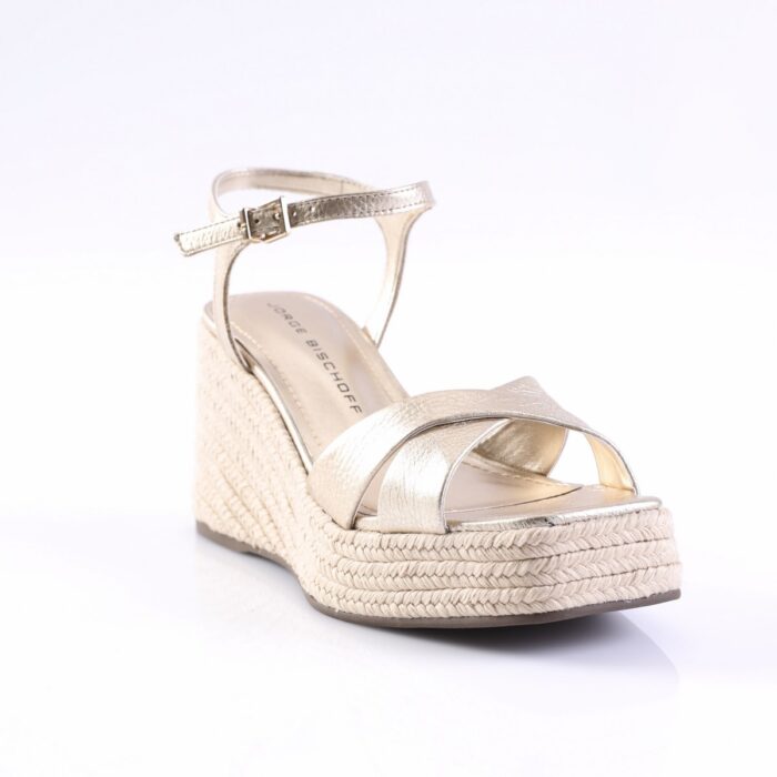 Gold metallic wedge sandal with braided espadrille heel and ankle strap with buckle on white background