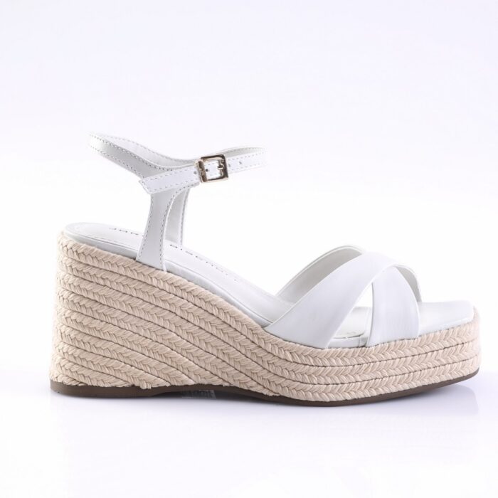 White wedge espadrille sandal with braided jute platform, white straps, and ankle buckle.