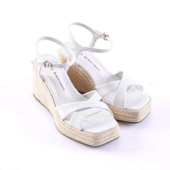 White wedge espadrille sandals with braided jute soles and thin ankle straps.