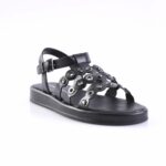 Black open-toe sandal with multiple strap cutouts and metal grommets, buckle strap at the ankle.