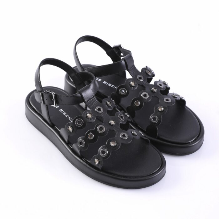 Black open-toe sandals with multiple metal eyelets and decorative cutouts on a low platform sole.
