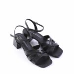 Black leather sandals with crisscross straps, ankle buckle, and a low block heel (Jorge Bischoff).