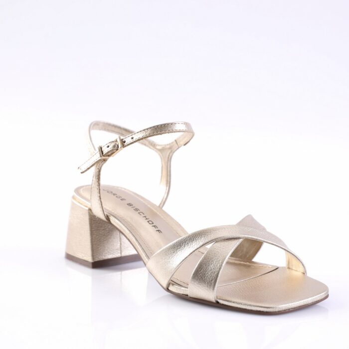 Gold metallic strappy sandal with buckle ankle strap and low block heel on a white background.