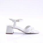 White open-toe sandal with twisted front straps, ankle strap with buckle, and a chunky block heel (side view).