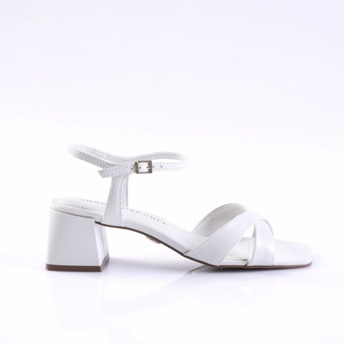 White open-toe sandal with twisted front straps, ankle strap with buckle, and a chunky block heel (side view).