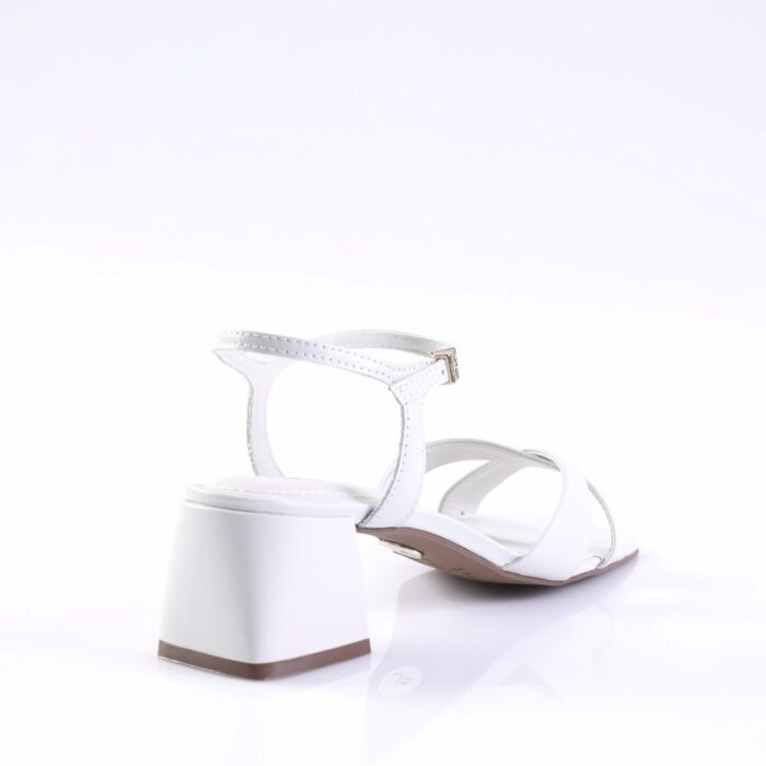 White strappy sandal with a chunky block heel and ankle strap, shown from a rear-side angle.