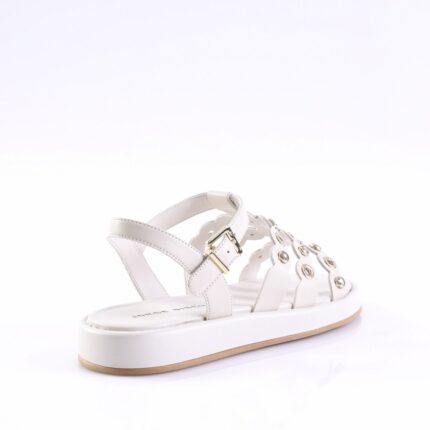 White leather sandal with multiple straps, gold buckle, and round metal grommets on a white platform sole with a light brown outsole