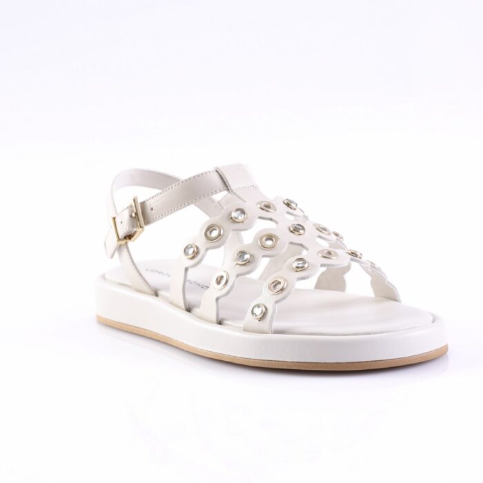 White women's sandal with an open toe, decorative metal eyelets across the strap, and an adjustable ankle strap with a gold buckle