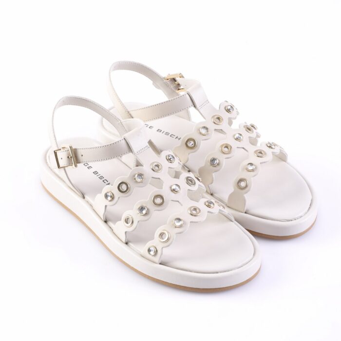 White women's sandals with scalloped cutouts and crystal accents, open toes and ankle buckles.