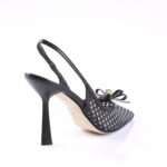 Black open-weave slingback high heel with bow detail and pointed toe, showcased from a rear angle for product viewing.