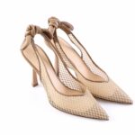 Beige mesh pointed-toe high heels with knotted straps at the back, on a white background