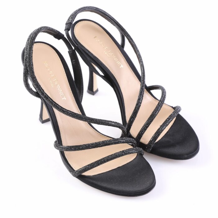 Black high-heeled sandals with glittery thin straps and open toes.