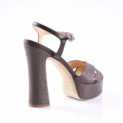 Woman's dark brown platform sandal with a chunky woven heel and ankle strap viewed from the back/side.