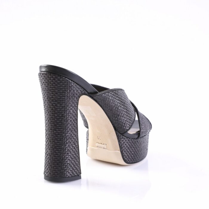 Back view of a black woven high-heeled mule with a thick platform heel.