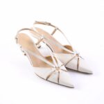 White slingback high-heeled sandals with pointed toes and cutout design