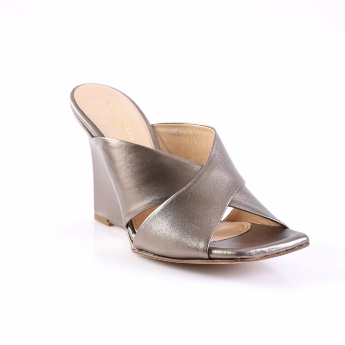 Metallic silver wedge sandal with crisscross straps and open toe on a white background.