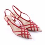 Red strappy heeled sandals with crisscross design and pointed toes ready for dressy occasions.",