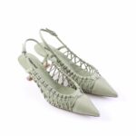 Sage green pointed-toe slingback heels with woven lattice sides (pair of women's sandals).
