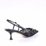 Black high-heeled sandal with thin straps and studded toe detail on a white background.