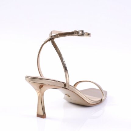 Gold metallic strappy high-heeled sandal with ankle buckle, viewed from the back-left side.
