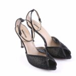Black high-heeled sandals with an ankle strap and glittery front panel, open-toe design.