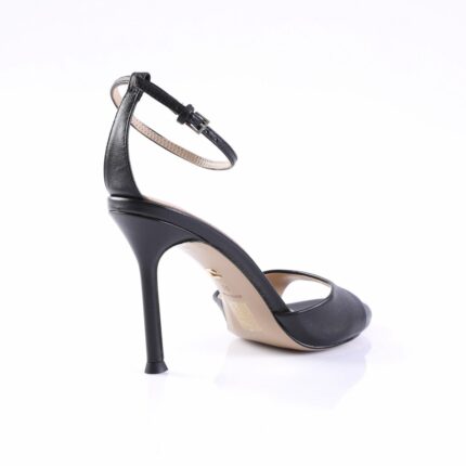 Black stiletto sandal with an ankle strap and buckle, viewed from the side to show the heel and sole edge