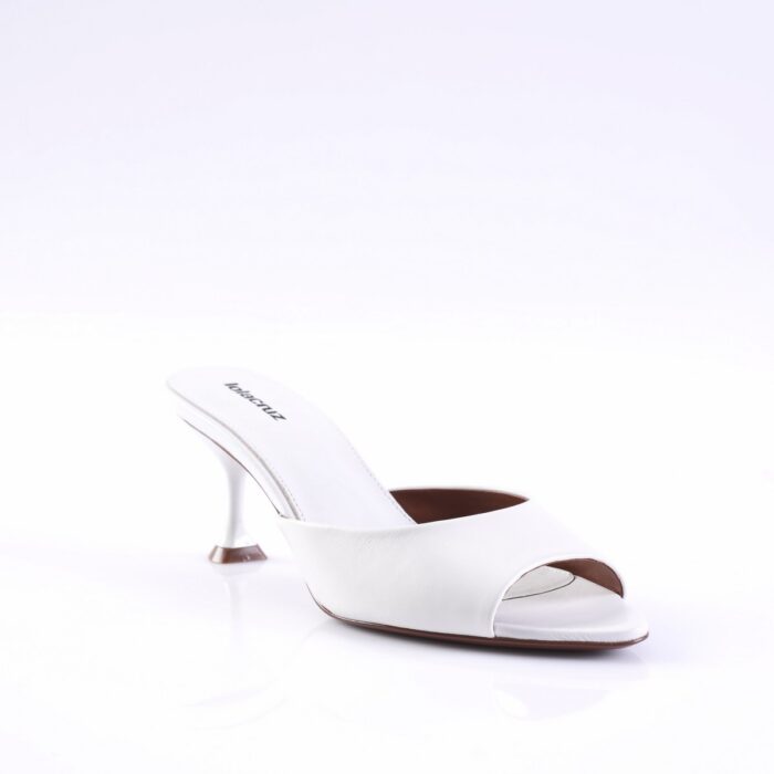 White open-toe mule with a curved slender heel on a glossy white surface, showcasing a minimalist high-heeled sandal