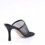 Black mesh mule heel with stiletto-style heel and open back, viewed from rear-right side.