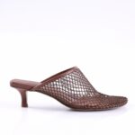 Brown woven-mesh mule with a low kitten heel on a white background, showcasing an open-toe design.