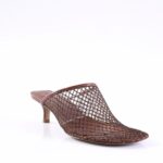 Brown lattice-mesh mule with a low kitten heel on a white studio backdrop.