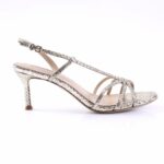 Silver snake-print strappy high-heeled sandal with ankle buckle and mid heel, showcasing a delicate T-strap design