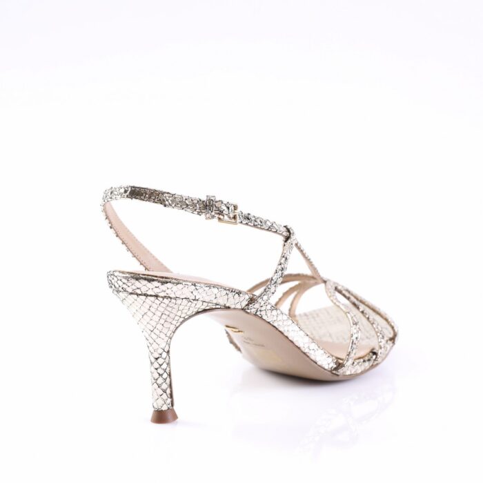 Gold snakeskin-printed strappy high-heeled sandal with an ankle strap on a white background.