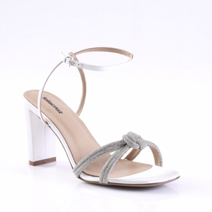 White strappy sandal with a clear block heel, rhinestone-embellished front straps, and a thin ankle buckle strap.