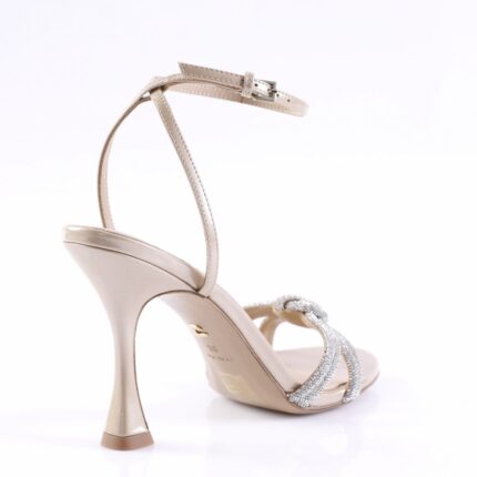 Gold high-heeled sandal with rhinestone-embellished straps and an ankle strap, shown from the side.