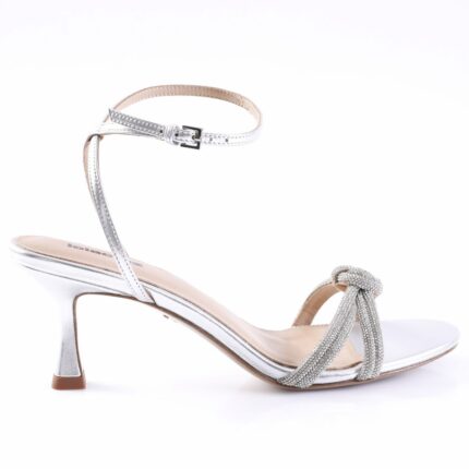 Silver strappy women's heeled sandal with an ankle strap and rhinestone-embellished bow at the toe