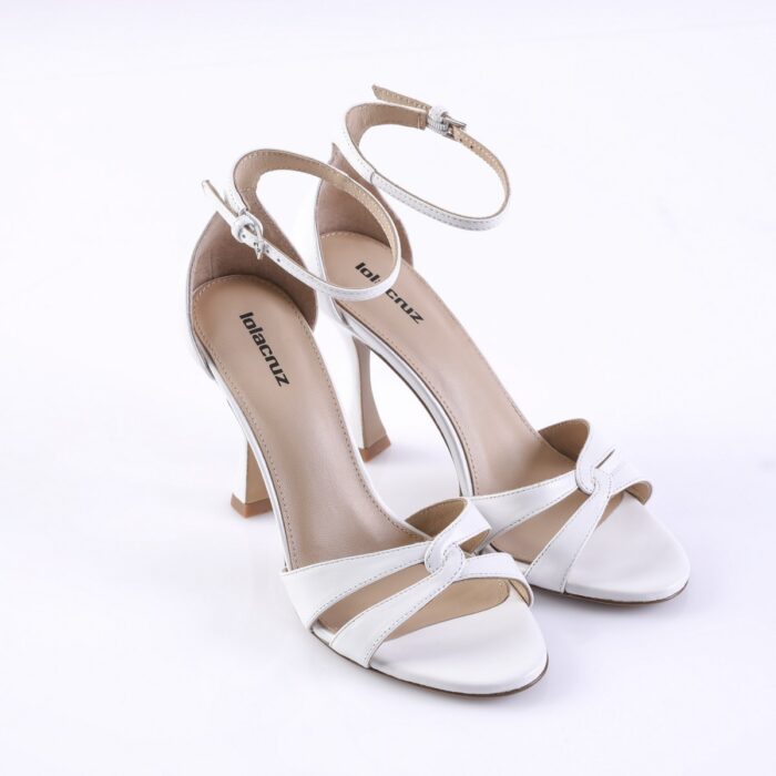 White open-toe high-heeled sandals with an ankle strap and knotted front strap, photographed on a white background.